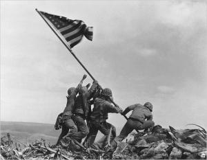 U.S. Marines of the 28th Regiment of the Fifth Division raise the American flag atop Mt. Suribachi.