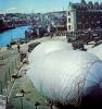 Barrage balloons being prepared for flight at a British port prior to D-Day.