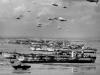 British Landing Craft Tanks' line the Normandy shore, each with a barrage balloon.