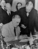 Roosevelt signing the declaration of war against Germany.