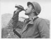 Soldier drinking Coca-Cola in Italy war theatre.