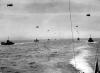 Convoy of landing craft on the way to Normandy. Each with its barrage balloon connected by a cable.