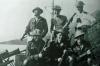 Soldiers carrying Lanchester submachine guns.