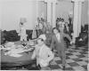 Reporters rushing excitedly through the White House with news of the Japanese surrender.