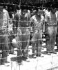 Japanese POWs at Guam, with bowed heads after hearing Emperor Hirohito make announcement of Japan's unconditional surrender.