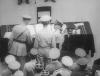 Douglas MacArthur giving a pen to Arthur Percival to sign the Japanese surrender document.