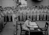 MacArthur signing Japanese surrender aboard USS Missouri.