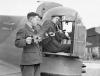 Armourers installing a Browning machine guns into the rear turret an Armstrong Whitley Mk V of 58th Squadron of RAF.