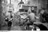 German anti-tank guns (rebuilt French R35 light tanks), motorcycles, and horse carts moving through a forest in northern Russia.