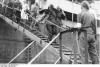 Refugees arriving at a western harbor, already occupied by British troops.