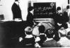 Jude student in front of the class. In the blackboard it's written: 'Jews are our enemy! Beware with jews!'