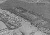 Aerial view of harbor with many landing crafts.