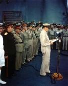 General MacArthur reads his speech at the formal Japanese surrender ceremony aboard Missouri.