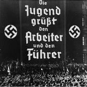 Nazi Youth Rally. The poster says: 'The Nazi Youth supports the worker and the Fuhrer'.