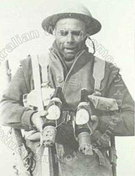 A soldier of the 6th Australian Division with a special kind of Italian anti-tank Molotov cocktail, consisting of a beer bottle and with petrol with a hand grenade tied to the bottom.