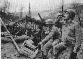 American soldiers drinking Coca-Cola in one of many the war theatre.