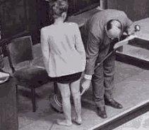 American medical expert Leo Alexander points to scars on the leg of Jadwiga Dzido, result of medical experiments at the Ravensbrueck concentration camp. 