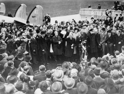 Prime-minister Neville Chamberlain showing the document signed by Munich Pact the participants.