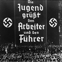 Nazi Youth Rally. The poster says: 'The Nazi Youth supports the worker and the Fuhrer'.