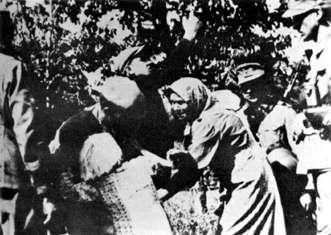 Photo of the SS soldier kidnaping a polish child for the 'Lebensborn' program.