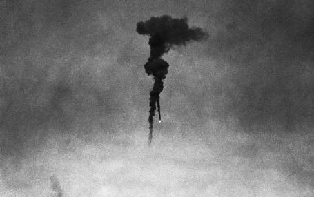 Two barrage balloons come down in flames after being shot by German war planes during an aerial attack.