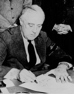 Roosevelt signing the declaration of war against Japan.