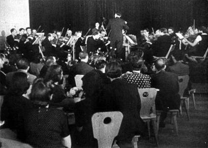 A concert in the concert hall in the ghetto from a propaganda film.