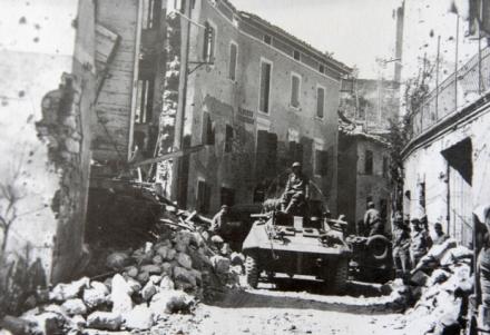 An M-8 Armored Vehicle of the Reconnaissance Squadron of the 1st Expeditionary Infantry Division enters Montese in Italy at the beginning of spring offensive launched by the Allies.
