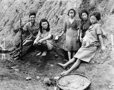 Four Korean comfort women (sex slaves), one pregnant, pose with a Chinese soldier who apparently helped free them from the Japanese.