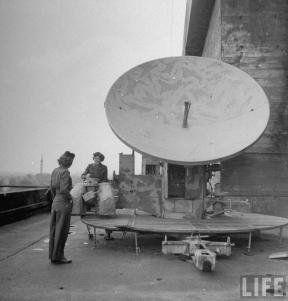 American WACs (Women's Army Corps) examining the radar atop German flak tower in the Tiergarten section of city following the capture of Berlin by Allied troops.
