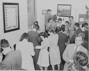 Reporters on telephones at the White House, transmitting news of the Japanese surrender.