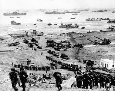 Reinforcements of men and equipment moving inland at Omaha Beach.