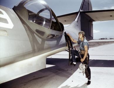 Jesse Rhodes Waller, a World War II Aviation Ordenanceman stationed at the Naval Air Station in Corpus Christi, Texas, installing a M1919 Browning machine gun in a US Navy PBY plane.