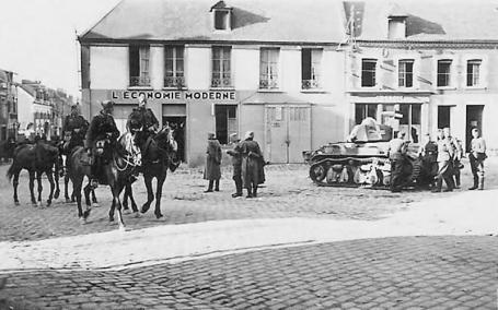 Wehrmacht cavalry pass by french Renault R35 tank.