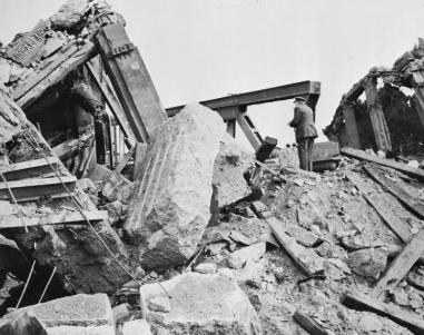 British Prime Minister, Winston Churchill, looks over the Rhine from the ruins of the west end of the bridge at Wesel during a visit to the front.