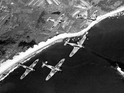 Canadian Hurricane fighters in flight over shore lines.