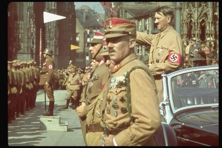 Hitler salutes German troops.