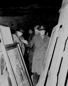 General Dwight D. Eisenhower, Supreme Allied Commander, accompanied by Gen. Omar N. Bradley, and Lt. Gen. George S. Patton, Jr., inspects art treasures stolen by Germans and hidden in salt mine in Germany.