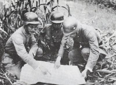 Officers of the Chinese 88th Division studying a map.