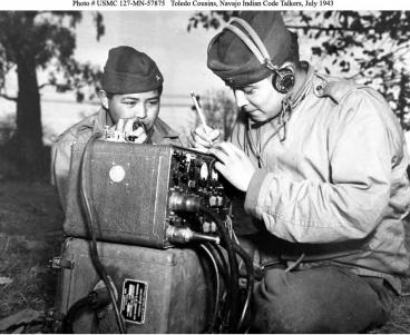 Preston Toledo and Frank Toledo, both Navajo Code Talkers and cousins, relay orders in the Navajo language on a field radio.