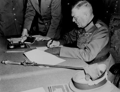 German Marshal Wilhelm Keitel at Russian Headquarters in Berlin signing the surrender document which declared that the hostilities would end next day.